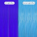 Fluorescent foil fringe curtain showing UV light purple effect vs normal blue effect - Tinsel Curtain / Fluorescent Blue