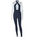 Detail of black halter neck jumpsuit featuring a cutout design and slim fit silhouette - S / Black
