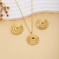 Golden spiral metal jewelry set with necklace and stud earrings on an elegant background - Gold Spiral Round Style