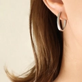 Minimalist silver titanium steel U-shaped hoop earrings worn on earlobe for modern style - Steel