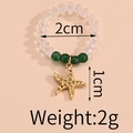 Elastic beaded ring with faceted clear beads, green accents and gold starfish charm - Green Bead Starfish Style (F-R584)