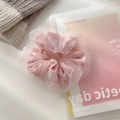 Detail shot of a pink floral mesh hair scrunchie with soft tulle texture and elegant pleats - Large / Large—Pink