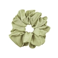 Close-up of a large light green elastic satin scrunchie with soft glossy silk texture - Satin Style / Pale Green