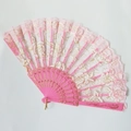 Detailed view of pink lace folding fan with gold rose embroidery and plastic ribs - Pink