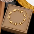 Macro shot of gold starfish linked bracelet on a luxury brown velvet jewelry box - Gold Stainless Steel Starfish Bracelet (SLE2190)
