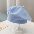 Light blue knitted beret for kids featuring a minimalist design on a white pedestal - Light Blue