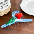 Light blue acetate tulip hair claw clip with red flower detail on wooden background - Sky Blue