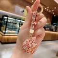Handheld crystal ball keychain with colorful rhinestones and a gold ring - Mixed Red