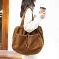 Braune Cord-Tragetasche mit Kordelzug und großen Taschen am Modell präsentiert - Braun