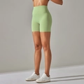 Side view of light green high-waisted yoga shorts showing peach-butt lifting effect - Dark Green