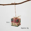 Mini Christmas gift box ornament with reindeer patterns and twine bow hanging on a wood branch - Elk Christmas Tree