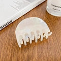 Elegant pearlescent white acetate hair claw clip in a half-round shape on a wood surface - 6.8cm / Mermaid White