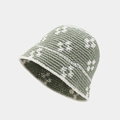 Detail view of the handmade olive green crochet bucket hat with white flower patterns - M (56-58cm) / Green