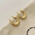Minimalist gold teardrop earrings with a polished mirror finish on canvas background - Mirror Polished Teardrop