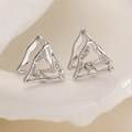 Symmetric silver hollow triangle earrings with 18K gold plating and zircons on ceramic tray - Silver