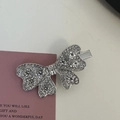 Sparkling silver bow hair clip featuring pink rhinestones on a decorative card - Silver/White Zirconia-Full Pave Bow