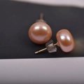 Macro shot of natural freshwater pink pearl earrings with clear silicone backings - 9mm / Pink