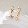 Gold star and moon asymmetric earrings featuring blue gemstone and face relief - Gold Tone with Aquamarine Stone
