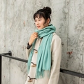 Mint green cashmere feel scarf with tassel edges worn with a beige duffle coat - Bean Green