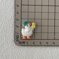 Resin duck figurine with green hat and boots on measuring mat for DIY crafts - Duck