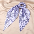 Detail view of a lavender satin scrunchie with blue evil eye prints and long ribbons - 7# Light Purple Blue Circle Eye