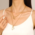 Layered gold heart pendant necklaces featuring thick short chain and thin long chain on model - Gold Tone Double-Layer Solid & Hollow Heart Necklace (KC Gold WG-0985)