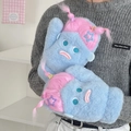 Cute blue plush monster doll with pink hair and star clips held by a model - Blue Monster Style