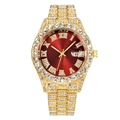 Detail of luxury gold iced-out watch featuring a red sunray dial and Roman numerals - Gold Red