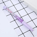 Purple quicksand liquid pen with silver glitter and 100% Smile print on grid background - Quicksand Pen With Text Purple