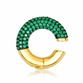 Detail of a C-shaped gold ear cuff featuring green zircons and a smooth metallic finish - Gold-Green Zirconia