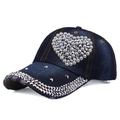 Detail of a denim baseball cap with a pearl heart design and silver conical studs - Adjustable / Dark Blue
