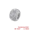 Detail view of 10mm copper hollow bead with zircon inlay and flower petal pattern - Hollow Clover Style (VZ382) / 7x10mm / White Gold