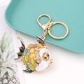 Close-up of golden crab keychain with colorful rhinestones and white enamel detail - Goldfish 1 (Multicolor)