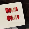 Handmade press-on nails with red cat eye finish and white floral patterns - Extra Small (XS)