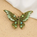 Vintage gold butterfly brooch with green rhinestones and crystals on sand background - Style 61/Ancient Gold Green Series