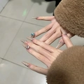 Detail shot of long almond press-on nails with glitter and large blue rhinestones decoration - Glue Type / Chestnut Color Diamond Style (BY1391)
