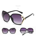 Polarized women's oversized sunglasses with black frame and golden camellia floral temple detail - Glossy Black Frame Gradient Grey Lens