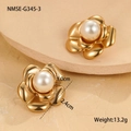 Macro view of golden camellia flower earrings with center pearl on a stone base - 18K Gold / Gold Camellia Stud Earrings
