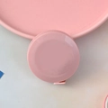 Portable pink mini tape measure for body sewing measurements in a round plastic case - Nordic Pink
