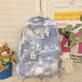 Detail of blue tie-dye canvas backpack with bear charm and decorative rabbit brooch - With 4A Badge and Blush Bear / Blue