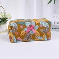 Mustard yellow floral quilted cosmetic bag with a pink bow and secure gold zipper - With Bow / Yellow Large Flower