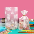 Matte clear treat bag with white feather print and golden twist tie closure - White Feather Style - Extra Small