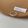 Detail of silver chain ring featuring a square clear gemstone on a cork surface - J2324 Chain Square Zircon Open