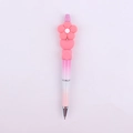 Close-up of pink beaded pen with cute silicone daisy flower, heart and square beads - Watermelon Red Flower