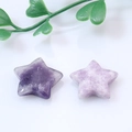 Natural star-shaped crystal pendants in dark and light purple on white background - Phosphosiderite