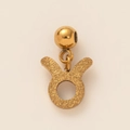 Macro view of gold-plated Taurus zodiac pendant with a textured matte finish - Frosted Taurus Zodiac Sign