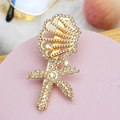 Detailed close-up of a gold starfish and seashell hair clip with sparkling rhinestones - Style 09-Conch & Starfish