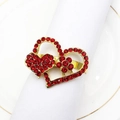 Golden metal napkin ring with red rhinestone heart and flower on a white napkin - Style 25-Gold Double Heart with Red Flower and Rhinestones