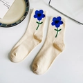 Mid-calf beige cotton socks featuring blue floral pattern displayed on a white table - One Size / Khaki