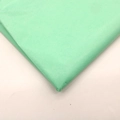 Macro shot of layered light green tissue paper with fine texture for gift wrapping - Tiffany Green